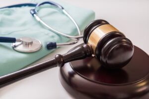 Common Type Of Personal Injury Cases - Gavel and stethoscope in background. Medical laws and legal concept